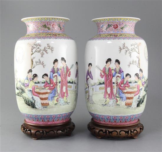 A pair of Chinese famille rose lantern shaped vases, height 29cm, wood stands